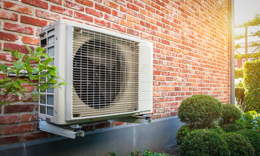 Heat pump mounted on a brick wall of Ohio home