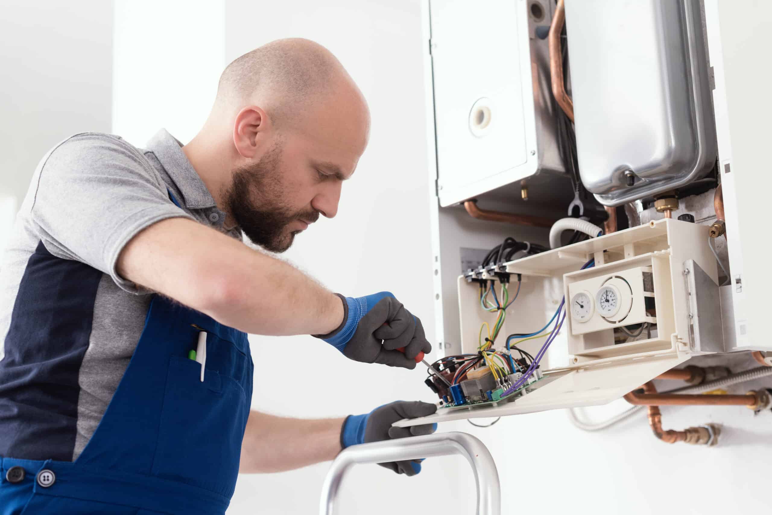 HVAC technician performing a maintenance service on a home heating system
