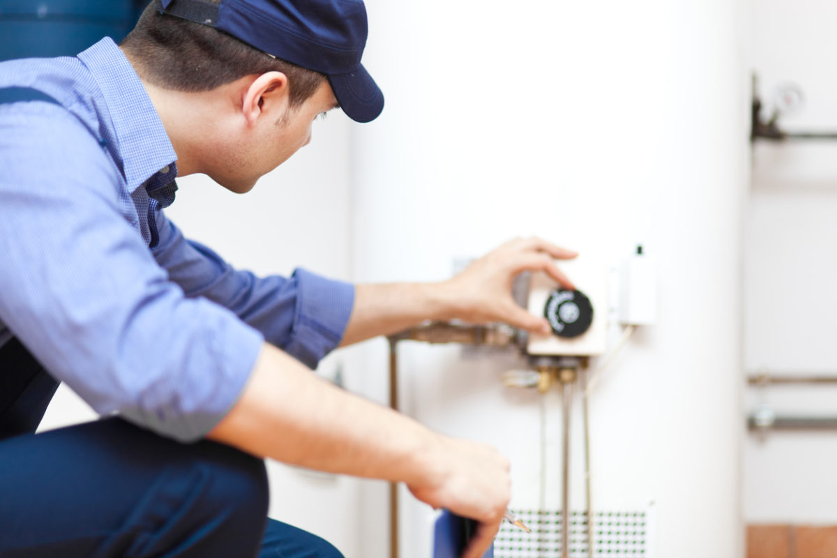 Technician installing a new water heater in an Ohio home