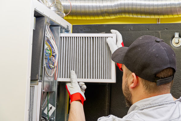 PK Wadsworth Technician performing furnace maintenance